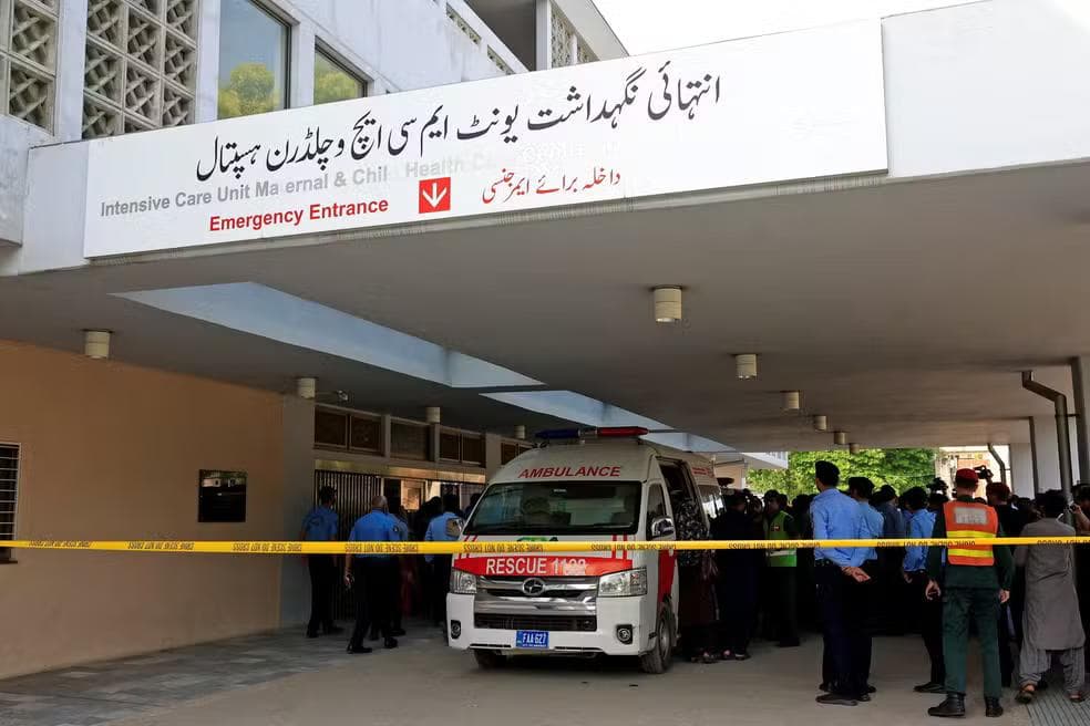 Policiais passam por uma ambulância em frente a uma unidade de terapia intensiva após um incêndio ter ocorrido no hospital do Instituto de Ciências Médicas do Paquistão (PIMS) em Islamabad, Paquistão — Foto: Reuters